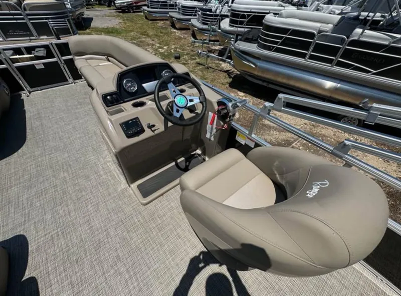 Slide: The Image of 2024 Ranger Reata 200C boat interior with steering console and seating. - 3
