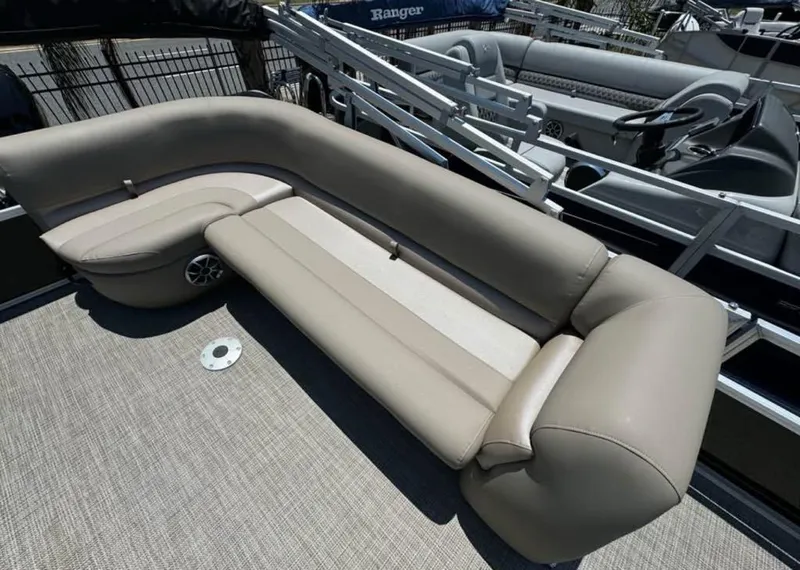 Slide: The Image of 2024 Ranger Reata 200C boat interior with beige seating and carpeted flooring. - 4