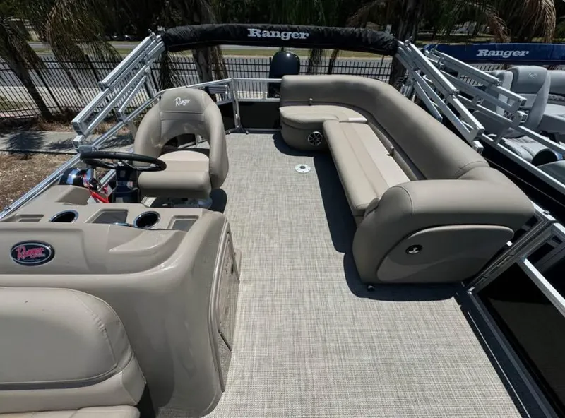 Slide: The Image of 2024 Ranger Reata 200C pontoon boat with spacious seating and modern design. - 5