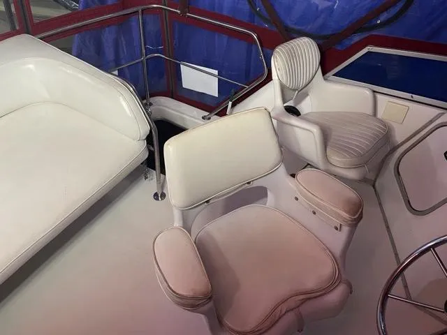 Slide: The Image of 1989 Sea Ray 300 Sedan Bridge interior seating area with white upholstery. - 13