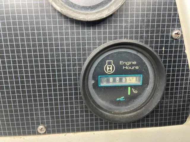 Slide: The Image of 1989 Sea Ray 300 Sedan Bridge engine hours gauge showing 8887.4 hours. - 15