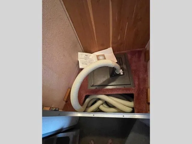 Slide: The Image of Interior compartment of 1989 Sea Ray 300 Sedan Bridge with hose and manual. - 27