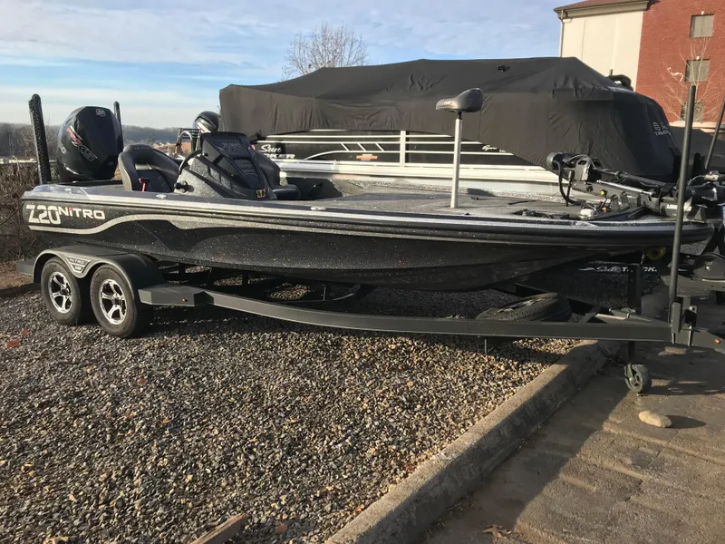 The Image of 2023 Nitro Z20 Pro bass boat on trailer, parked outdoors. - 0