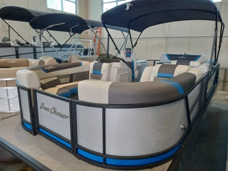 Slide: The Image of 2023 SunChaser Geneva Sport 23 SB pontoon boat with blue and gray seating. - 2