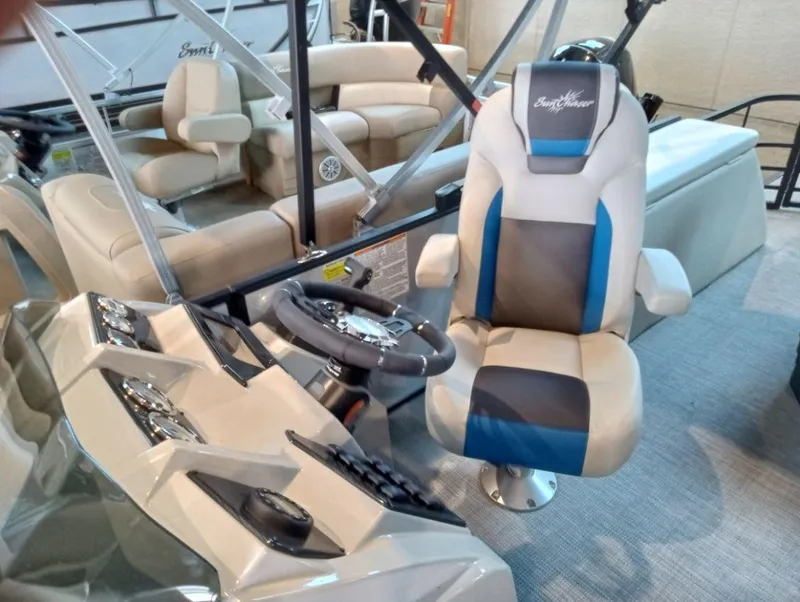 Slide: The Image of 2023 SunChaser Geneva Sport 23 SB boat interior with captain's chair and steering console. - 3