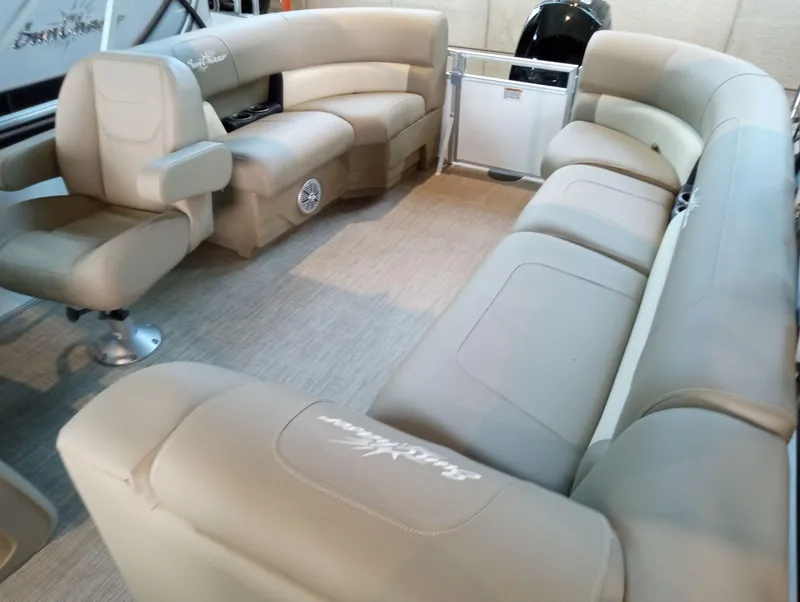 Slide: The Image of 2023 SunChaser Vista 20 LR pontoon boat interior with beige seating and spacious layout. - 2