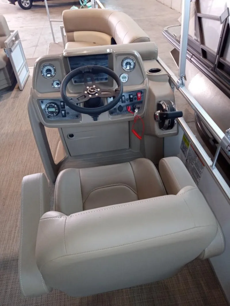 Slide: The Image of 2023 SunChaser Vista 20 LR boat cockpit with steering wheel and control panel. - 3