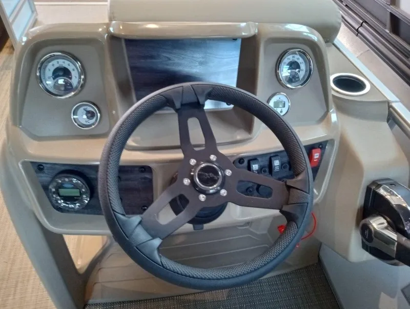 Slide: The Image of 2023 SunChaser Vista 20 LR boat dashboard with steering wheel and control panel. - 5