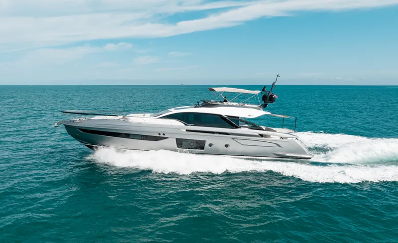 Slide: The Image of 2022 Azimut S8 yacht cruising on open sea under clear blue sky. - 1
