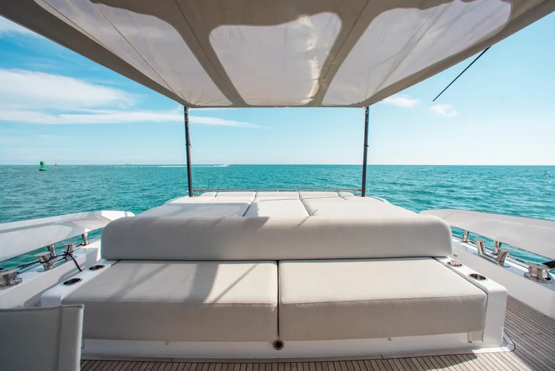 Slide: The Image of Azimut S8 2022 yacht deck with sunbed, ocean view, and canopy. - 23
