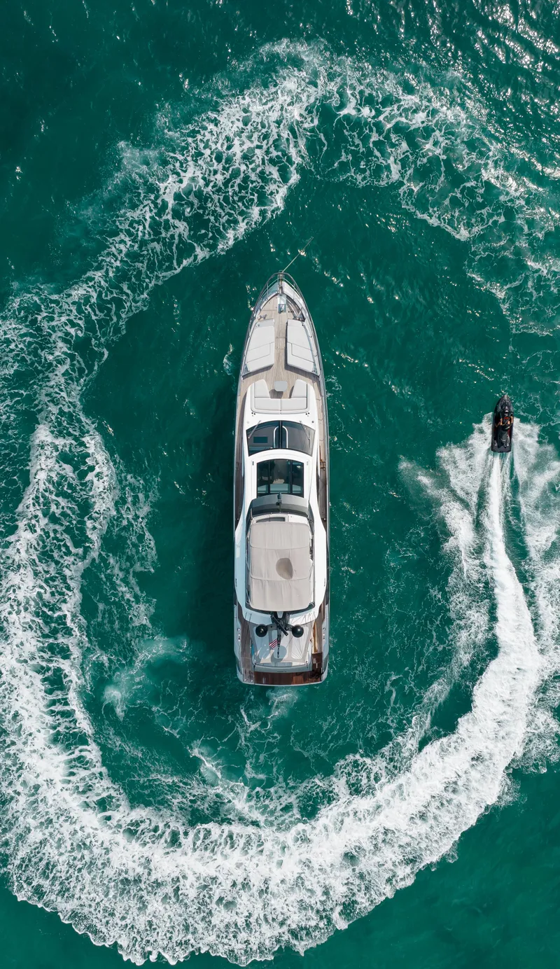 Slide: The Image of Aerial view of 2022 Azimut S8 yacht with jet ski in turquoise water. - 3