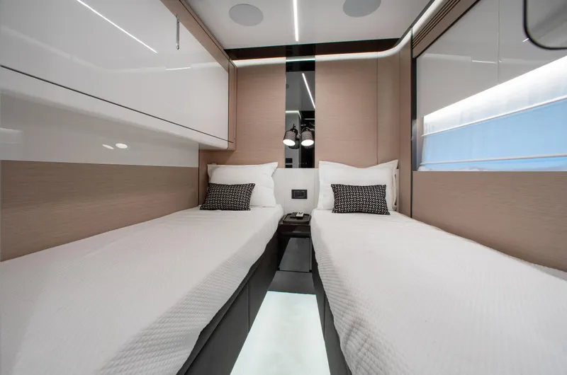 Slide: The Image of Luxurious twin cabin interior of 2022 Azimut S8 yacht, featuring modern design and elegant bedding. - 43