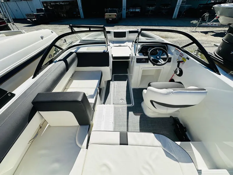 Slide: The Image of 2023 Bayliner DX 2050 boat interior with seating and steering console. - 10