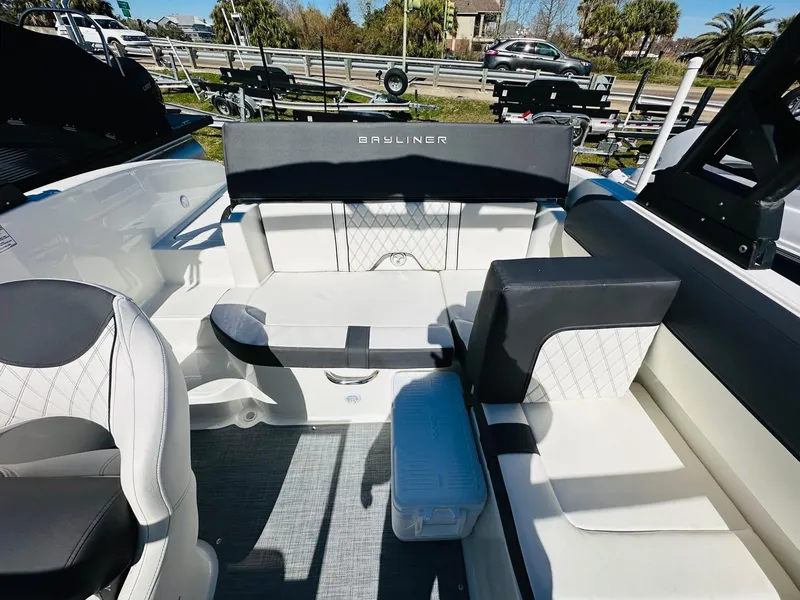 Slide: The Image of 2023 Bayliner DX 2050 boat interior with seating and storage. - 12