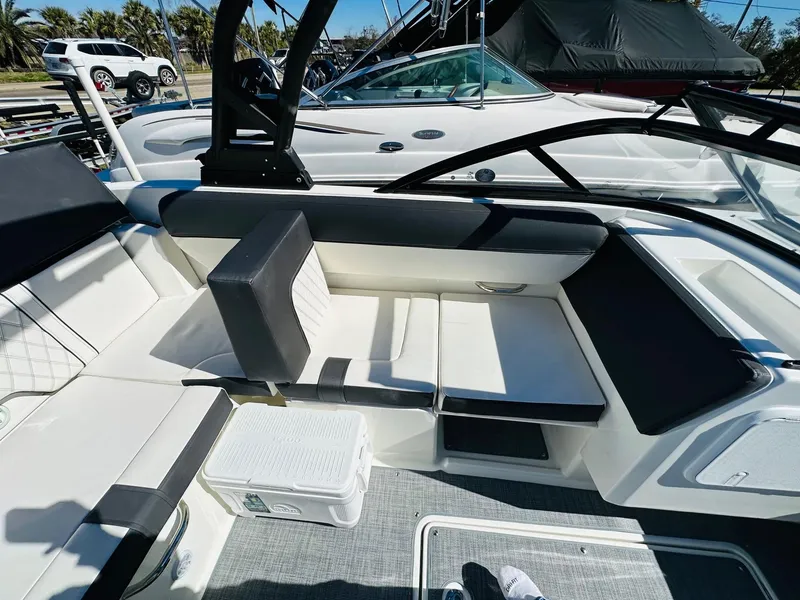 Slide: The Image of 2023 Bayliner DX 2050 boat interior with white and black seating. - 13