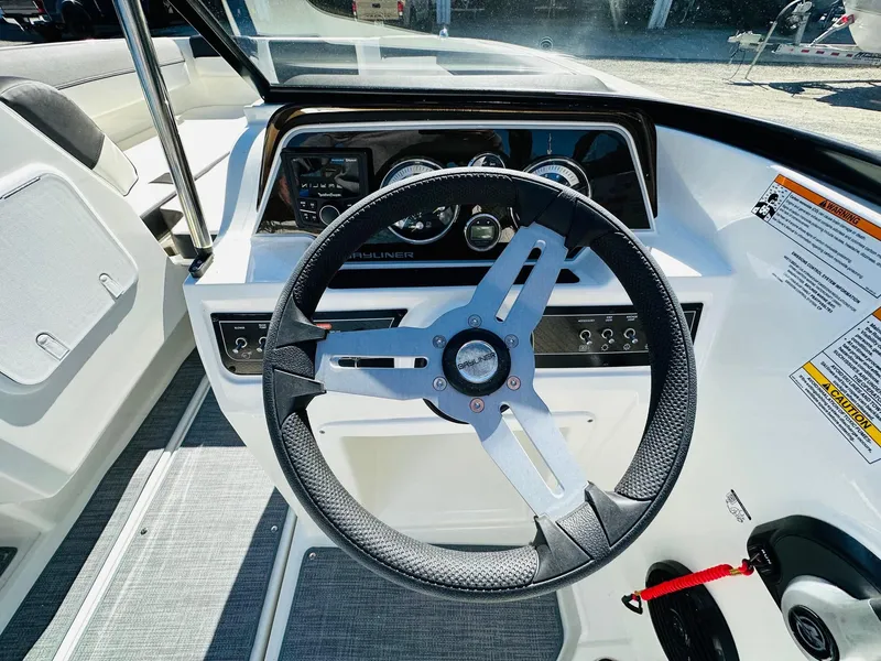 Slide: The Image of 2023 Bayliner DX 2050 boat steering wheel and dashboard. - 15