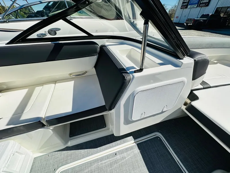 Slide: The Image of 2023 Bayliner DX 2050 boat interior with seating and storage compartments. - 16