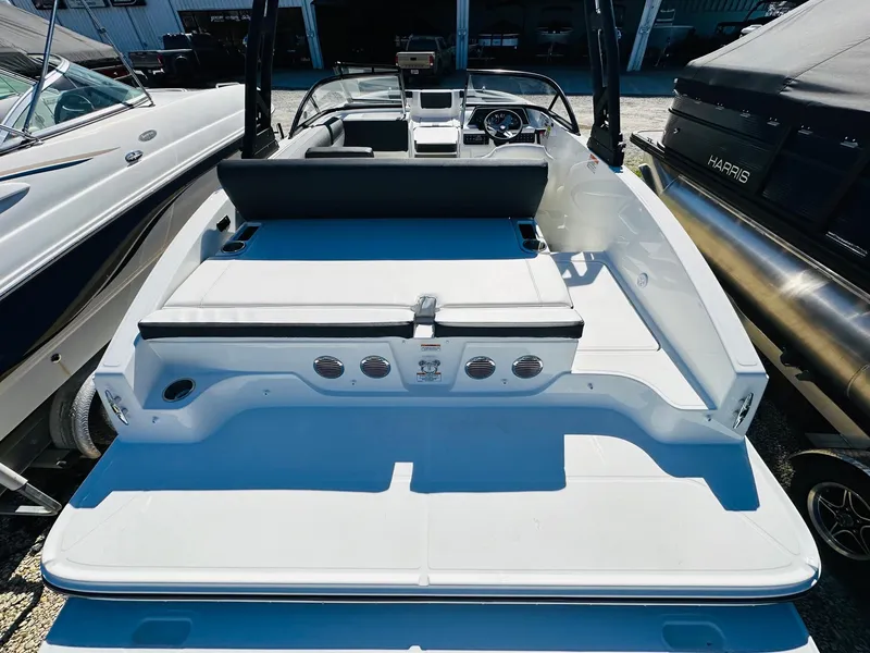 Slide: The Image of 2023 Bayliner DX 2050 boat, rear view, docked between other boats. - 6