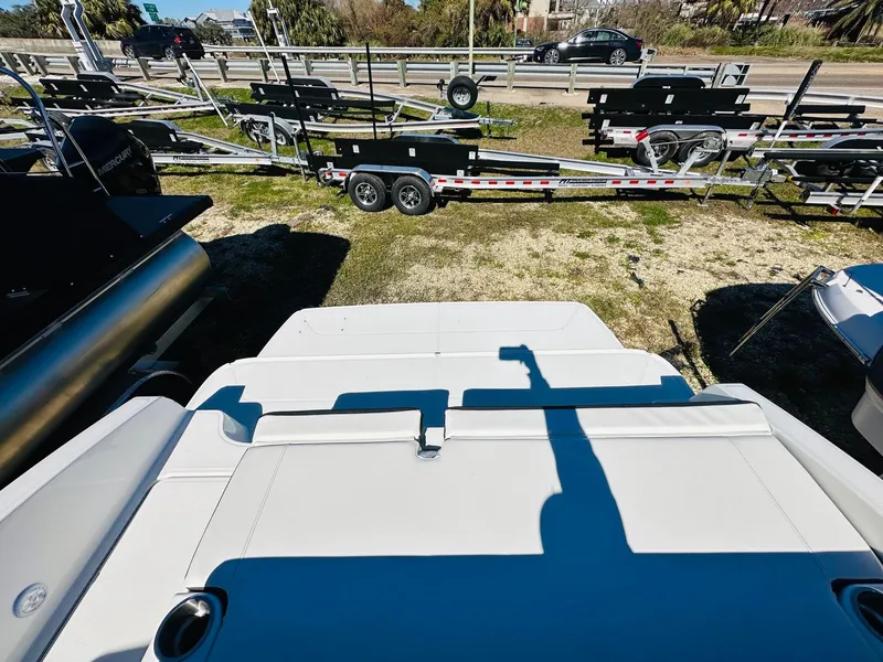 Slide: The Image of 2023 Bayliner DX 2050 boat rear view with trailers in the background. - 7