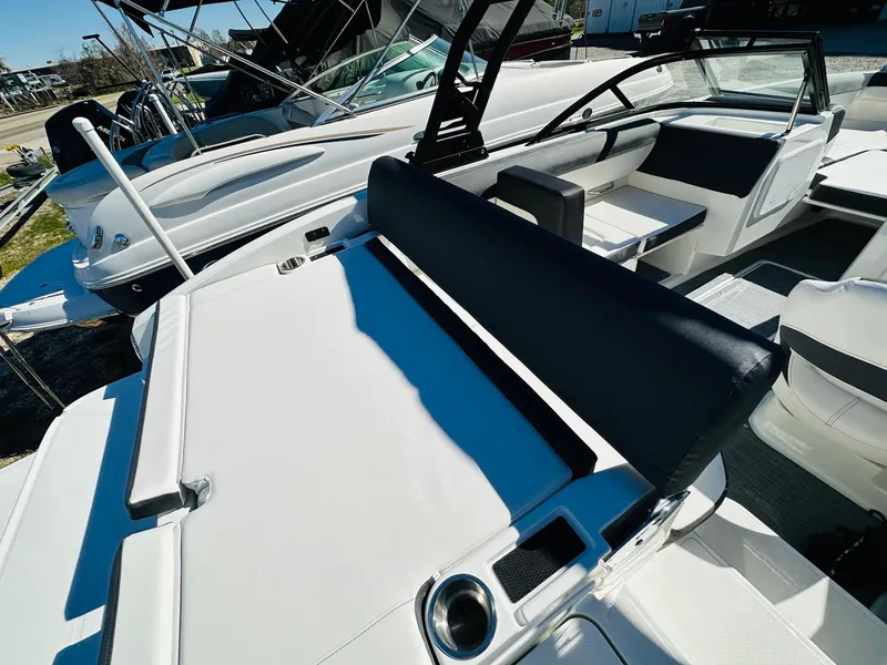 Slide: The Image of 2023 Bayliner DX 2050 boat interior with seating and cup holders. - 9