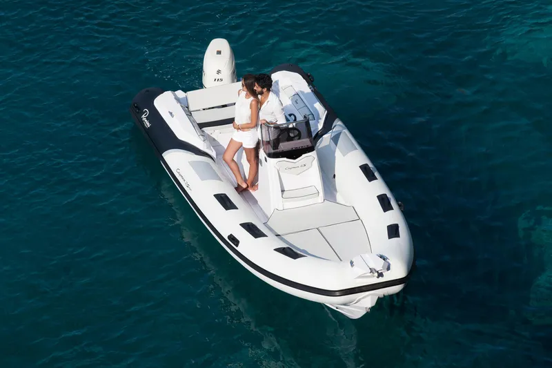 Slide: The Image of 2023 Ranieri CAYMAN 21 SPORT inflatable boat on clear blue water. - 7