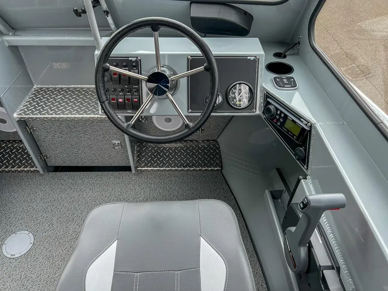 Slide: The Image of 2023 Hewescraft 210 Sea Runner ET boat interior with steering wheel and control panel. - 6