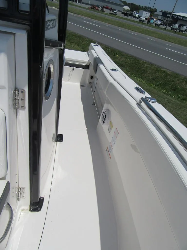 Slide: The Image of 2023 Robalo R230 Center Console boat deck with white interior and side rail. - 11