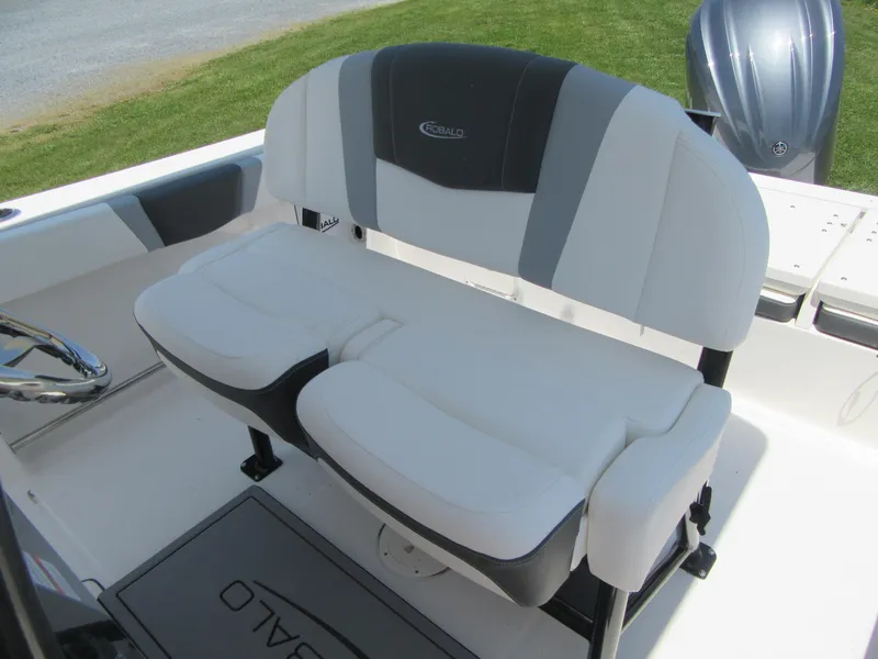 Slide: The Image of 2023 Robalo R230 Center Console boat seating area with cushioned bench. - 13