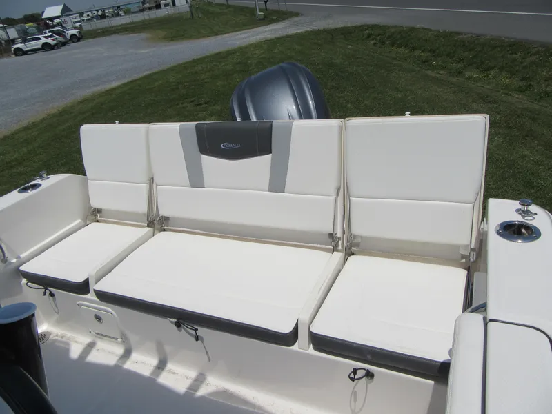 Slide: The Image of 2023 Robalo R230 Center Console boat seating area with cushioned seats. - 16