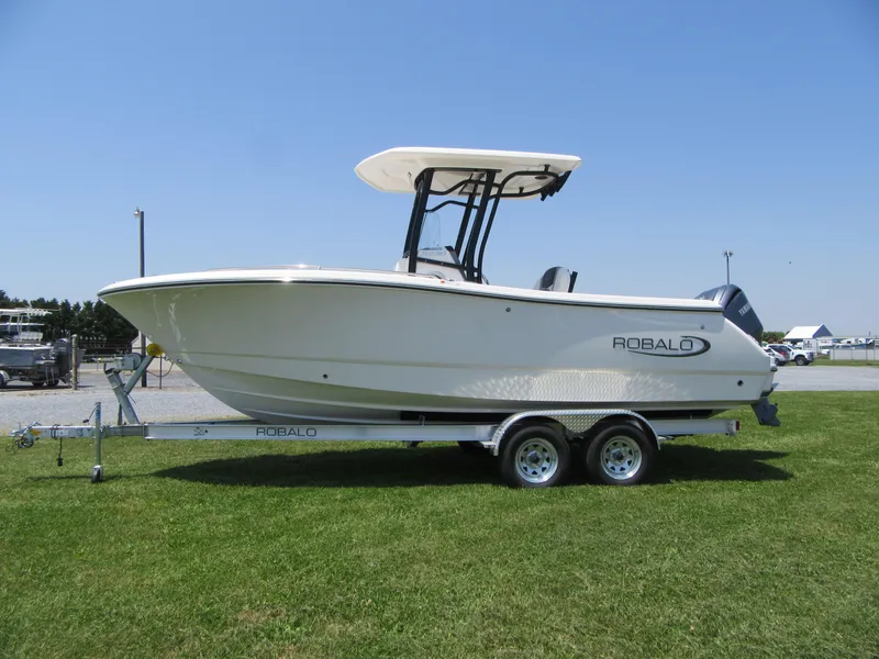 Slide: The Image of 2023 Robalo R230 Center Console boat on a trailer, side view. - 4