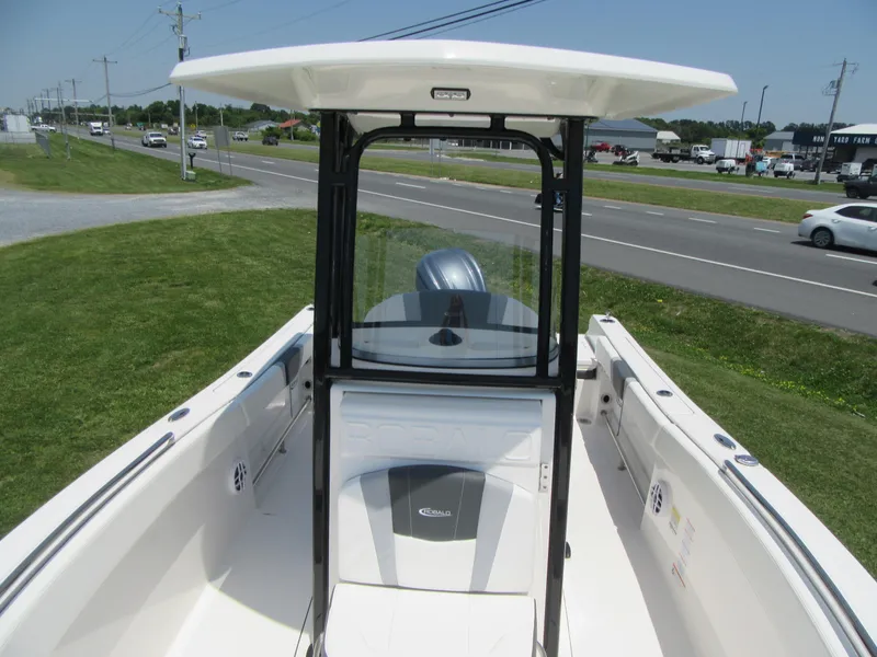 Slide: The Image of 2023 Robalo R230 Center Console boat on display near a road. - 7
