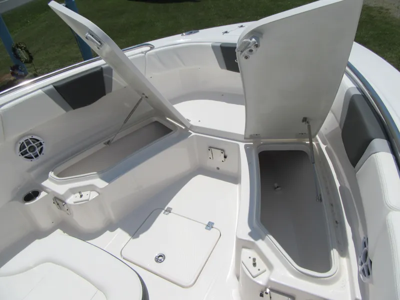 Slide: The Image of 2023 Robalo R230 Center Console boat with open storage compartments. - 8
