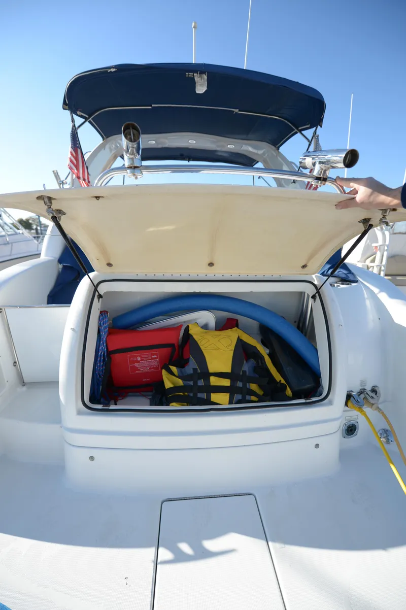 Slide: The Image of 2007 Formula 34 PC boat storage compartment with life jacket and equipment. - 13