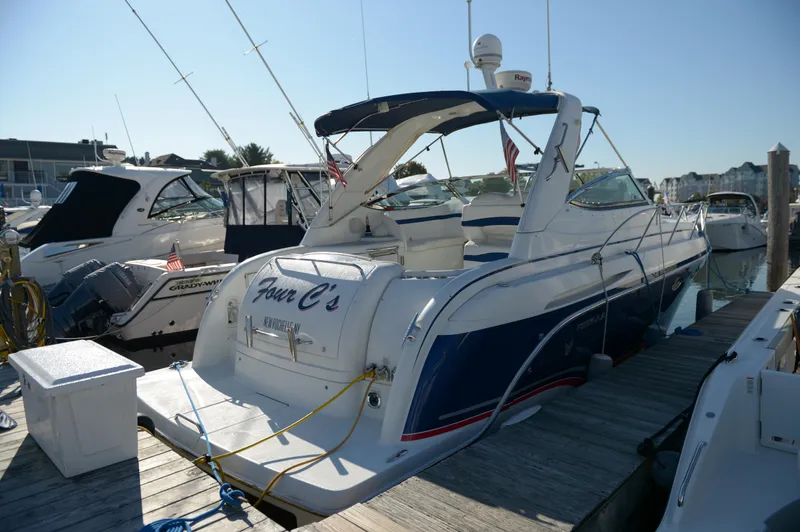 Slide: The Image of 2007 Formula 34 PC yacht docked at marina, featuring sleek design and blue accents. - 21