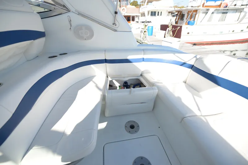 Slide: The Image of 2007 Formula 34 PC yacht interior with white and blue seating, open storage compartment. - 31