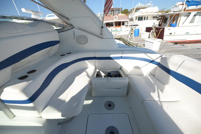 Slide: The Image of 2007 Formula 34 PC yacht interior with white and blue seating, docked at marina. - 32