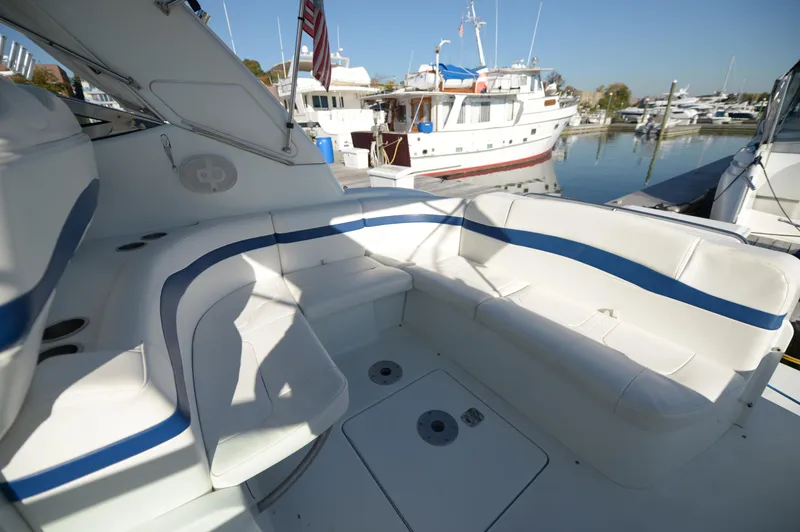 Slide: The Image of 2007 Formula 34 PC boat with white and blue seating in a marina. - 34