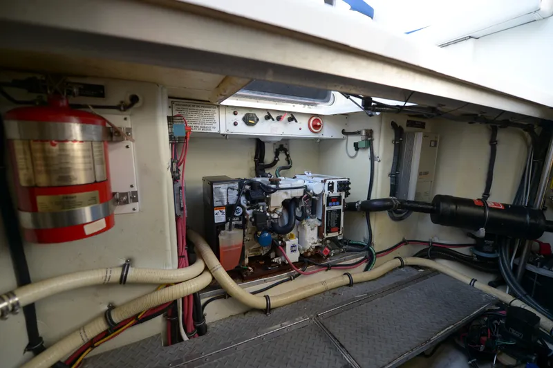 Slide: The Image of Engine room of a 2007 Formula 34 PC boat, featuring wiring and fire extinguisher. - 44