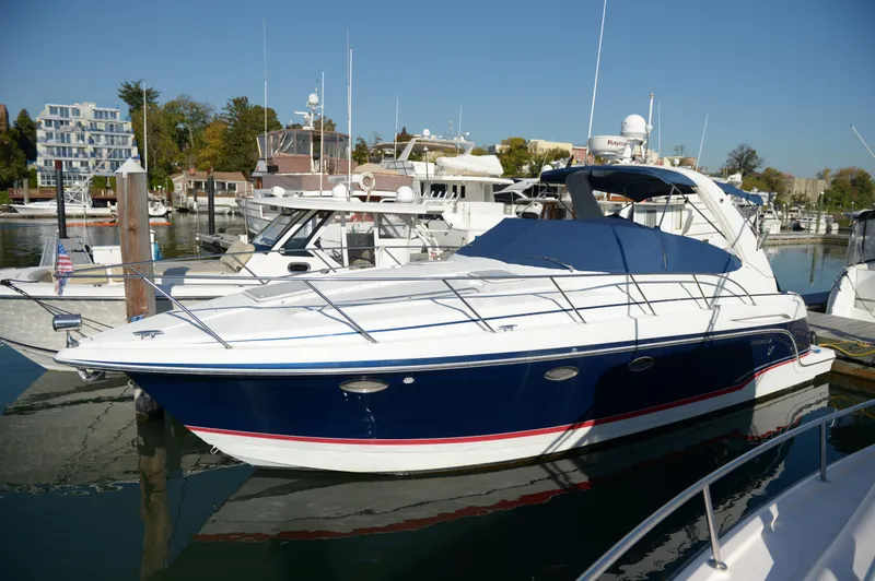 Slide: The Image of 2007 Formula 34 PC yacht docked at marina, featuring sleek design and blue hull. - 6