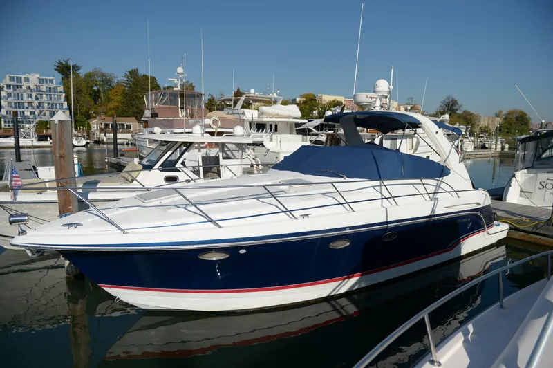 Slide: The Image of 2007 Formula 34 PC yacht docked in marina, featuring sleek design and blue hull. - 7