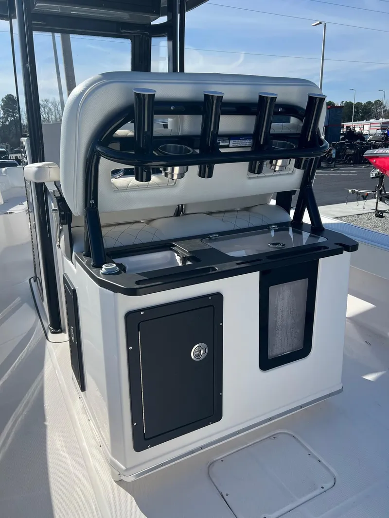 Slide: The Image of 2023 Blue Wave 2600 Makaira boat with rod holders and storage compartments. - 12