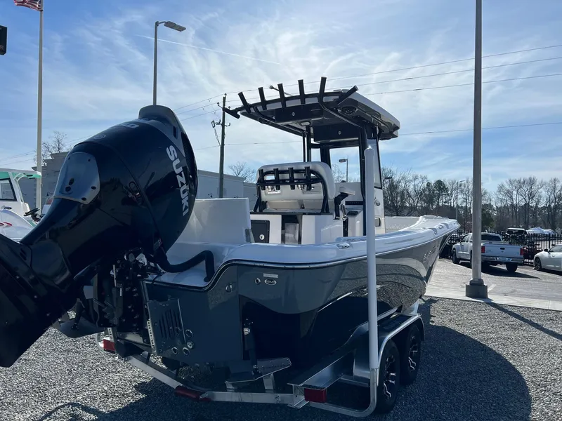 Slide: The Image of 2023 Blue Wave 2600 Makaira boat with Suzuki outboard motor on trailer. - 2