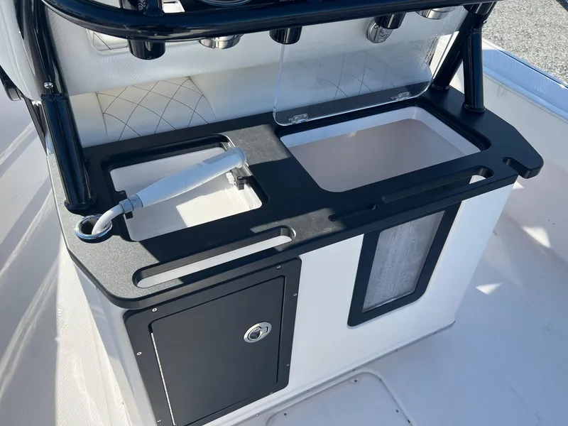 Slide: The Image of 2023 Blue Wave 2600 Makaira boat console with storage and rod holders. - 3