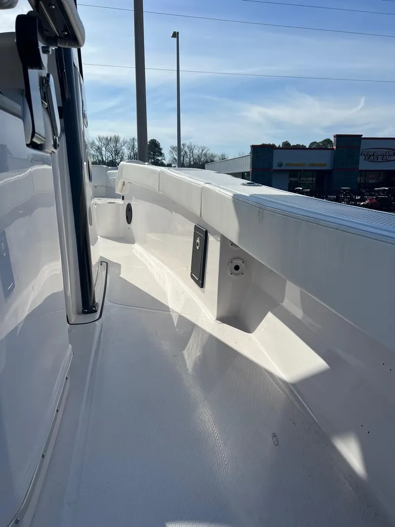 Slide: The Image of 2023 Blue Wave 2600 Makaira boat interior, white deck and side rail. - 5