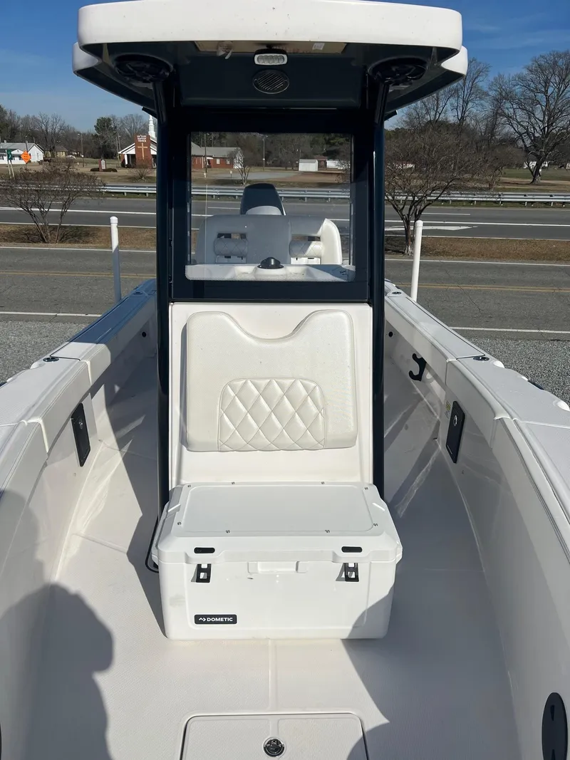 Slide: The Image of 2023 Blue Wave 2600 Makaira boat interior with seating and storage. - 9