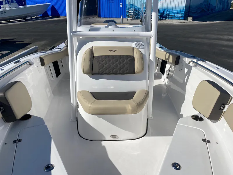Slide: The Image of 2021 Tidewater 210 LXF boat interior with beige seating and white deck. - 11