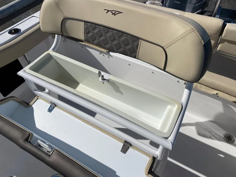 Slide: The Image of 2021 Tidewater 210 LXF boat with open storage compartment and cushioned seating. - 13