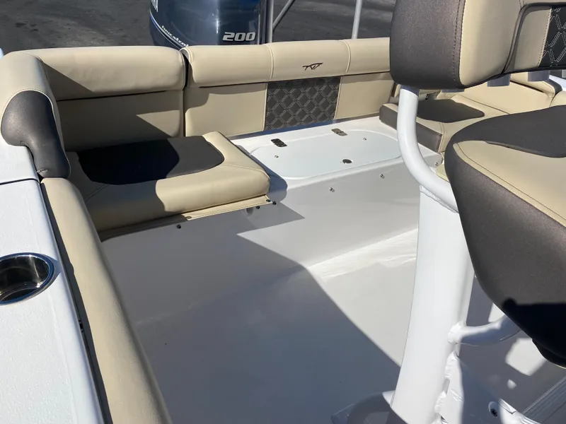 Slide: The Image of 2021 Tidewater 210 LXF boat interior with beige seating and Yamaha 200 outboard motor. - 18