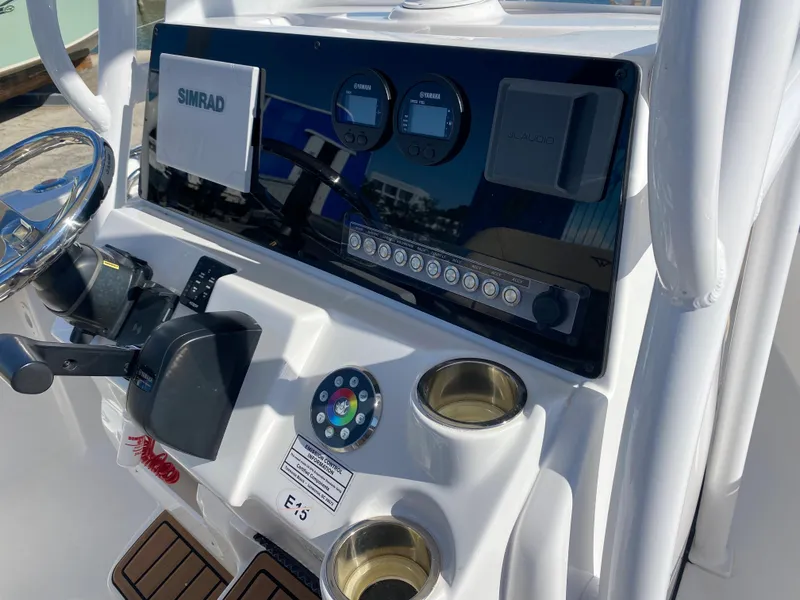 Slide: The Image of 2021 Tidewater 210 LXF boat dashboard with Simrad electronics and control panel. - 19