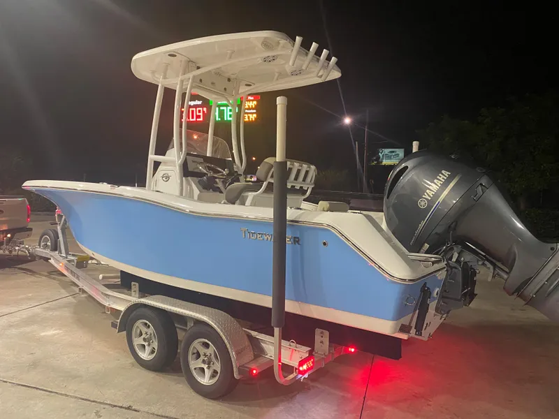 Slide: The Image of 2021 Tidewater 210 LXF boat on trailer with Yamaha outboard motor at night. - 2